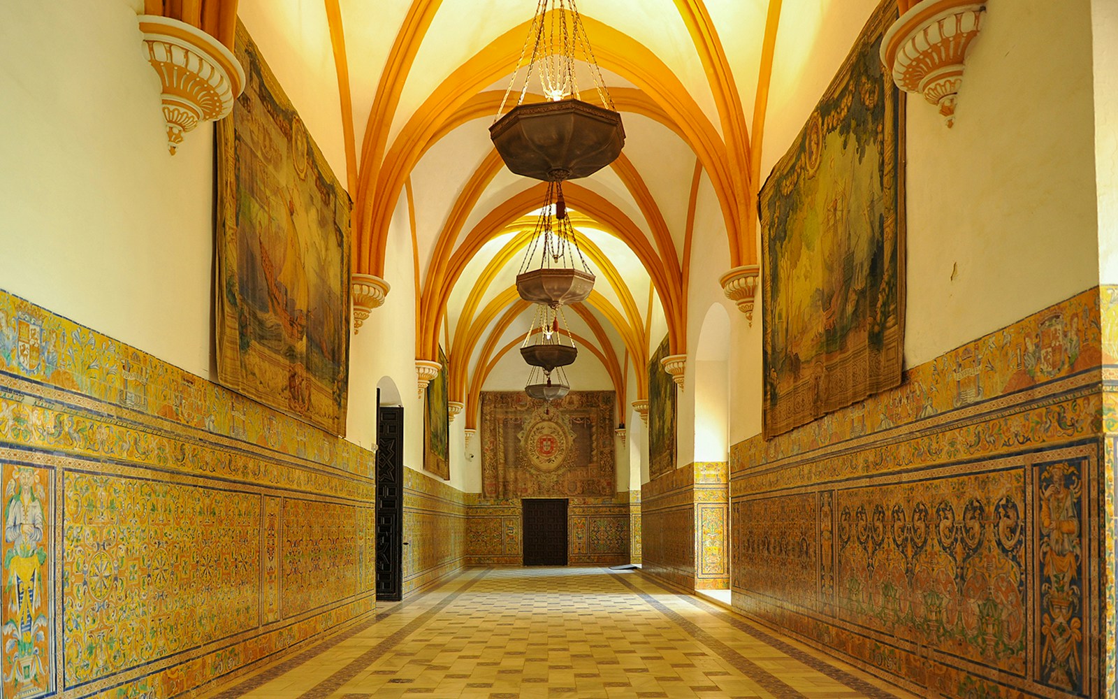 Gothic hall with intricate arches in the Alcázar of Seville, Andalusia, Spain.