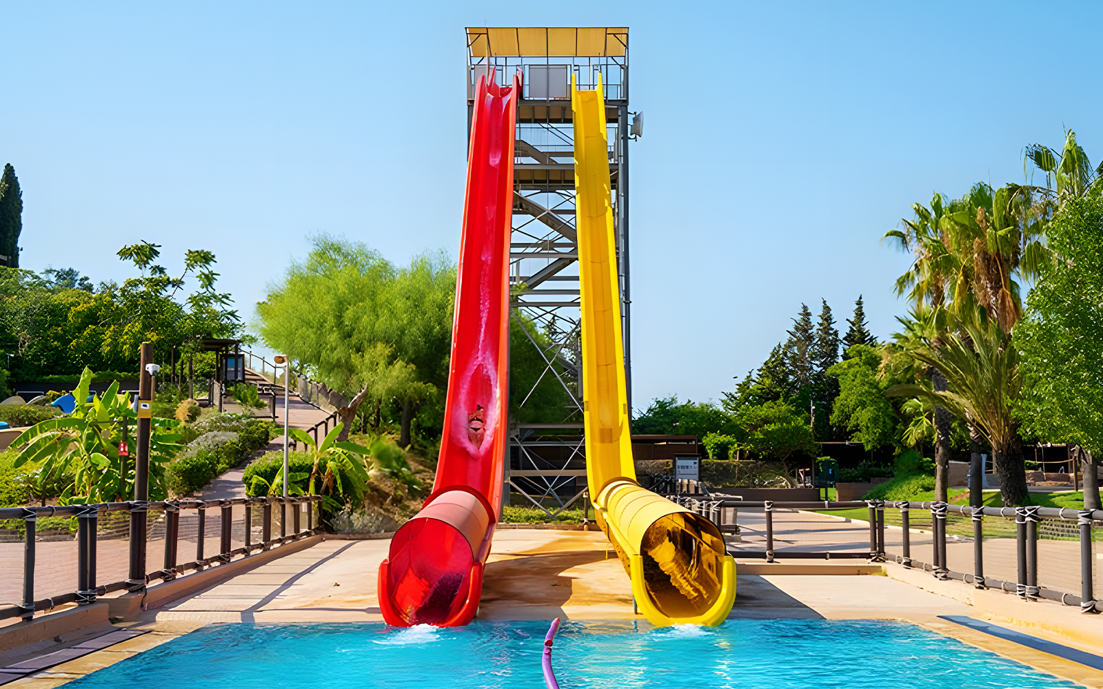 Kamikaze slide at Aquopolis Torrevieja with red and yellow slides leading into a pool.