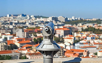 Telescope overlooking Lisbon from Church of Graca viewpoint.