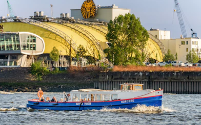Boat cruising past Hamburg's Stage Theater during 2-hour harbor tour.