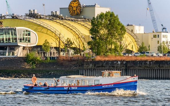 Boat cruising past Hamburg's Stage Theater during 2-hour harbor tour.