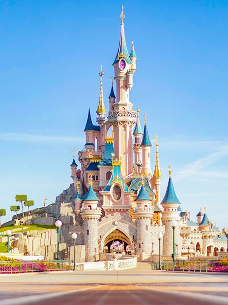 Sleeping Beauty Castle at Disneyland Paris with clear blue sky.