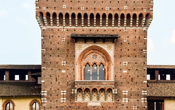 Battlements of Sforza Castle with detailed brickwork and arched windows, Milan.