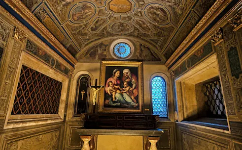 Renaissance artwork in a Florentine osteria, featuring religious imagery and ornate ceiling.