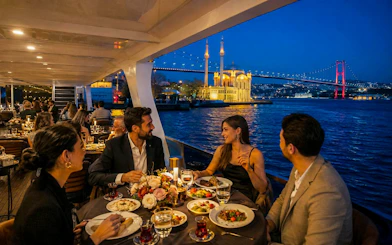 Dinner cruise on the Bosphorus with view of Ortaköy Mosque and Bosphorus Bridge, Istanbul.
