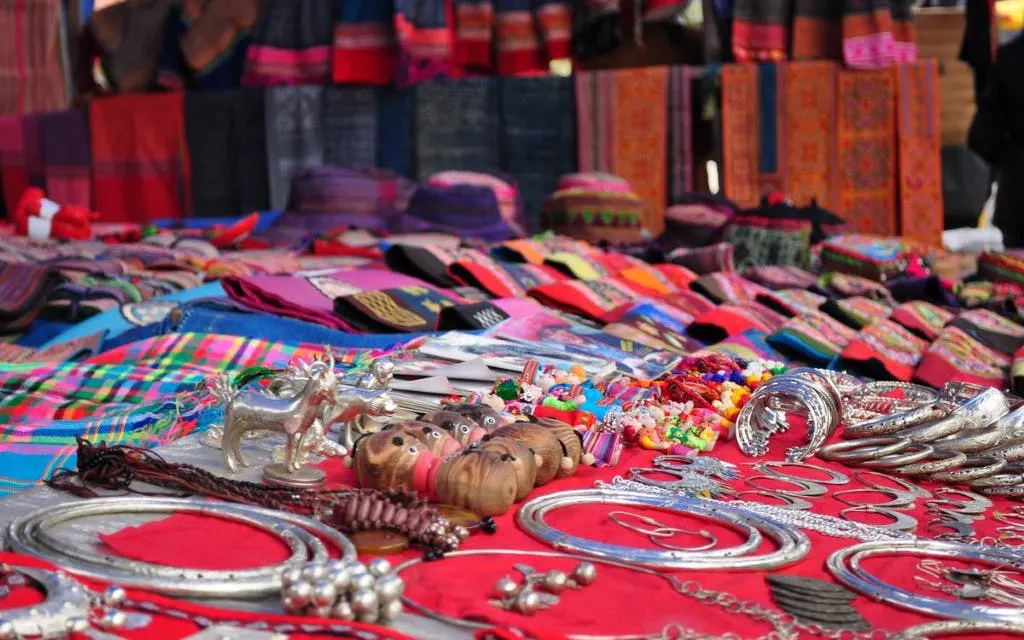 Handcrafted goods and textiles displayed at Bac Ha Market, Vietnam.
