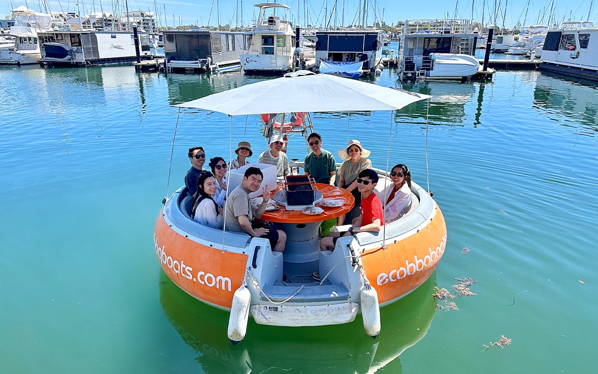 People enjoying a self-drive electric BBQ boat tour in Mandurah marina.