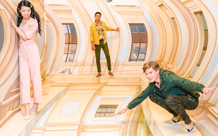 Guests interacting with optical illusions at TiLT Museum, American Dream.