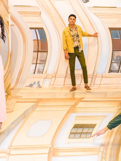 Guests interacting with optical illusions at TiLT Museum, American Dream.