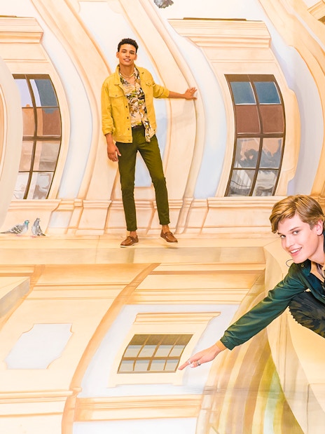 Guests interacting with optical illusions at TiLT Museum, American Dream.