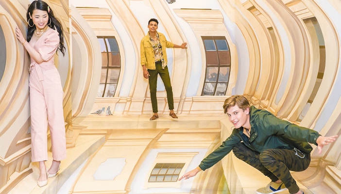 Guests interacting with optical illusions at TiLT Museum, American Dream.