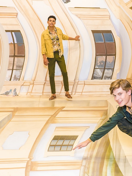 Guests interacting with optical illusions at TiLT Museum, American Dream.