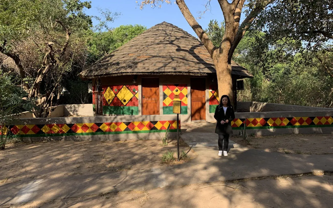 Traditional Zulu hut with colorful geometric patterns in Durban, South Africa.