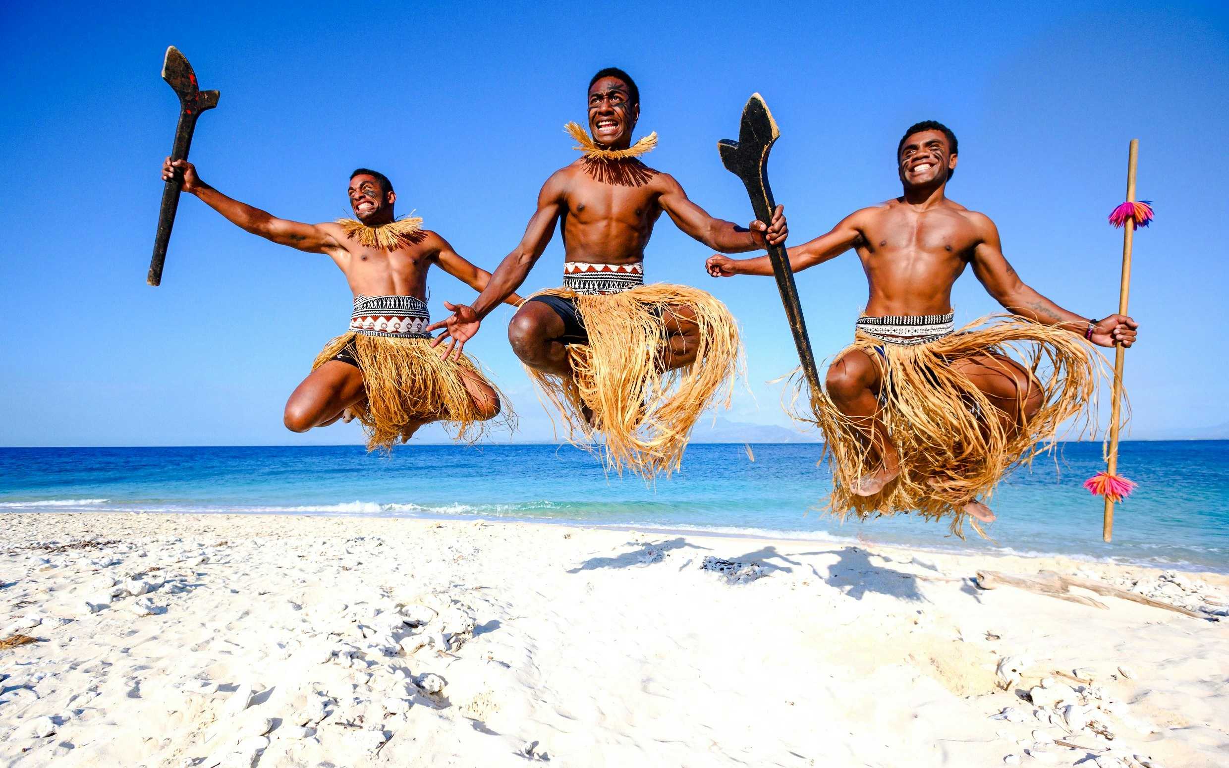 Traditional Meke dance performance on South Sea Island beach, Fiji.