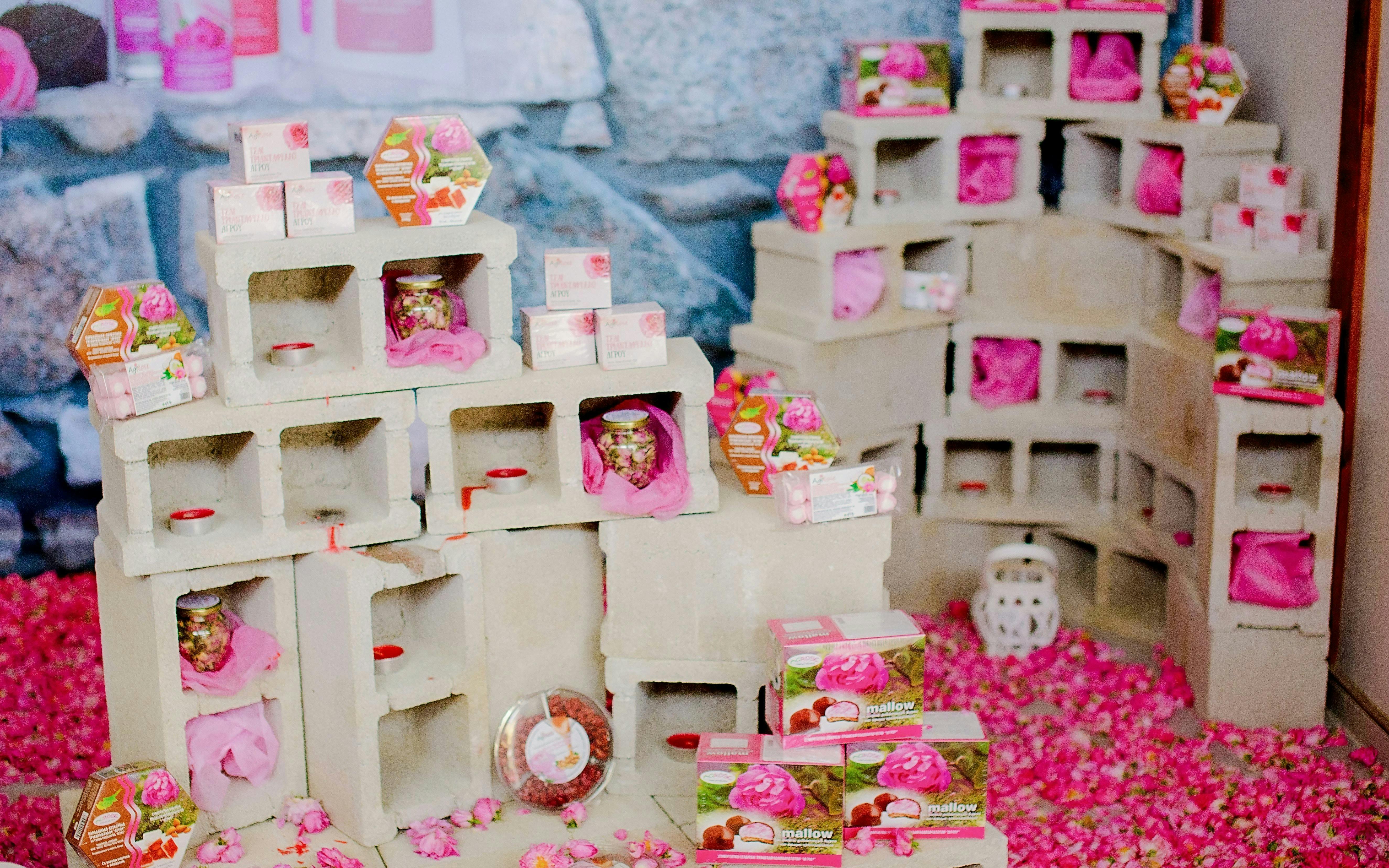 Rose products display at the Rose Festival in Agros, Cyprus, featuring soaps and sweets.