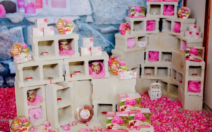 Rose products display at the Rose Festival in Agros, Cyprus, featuring soaps and sweets.