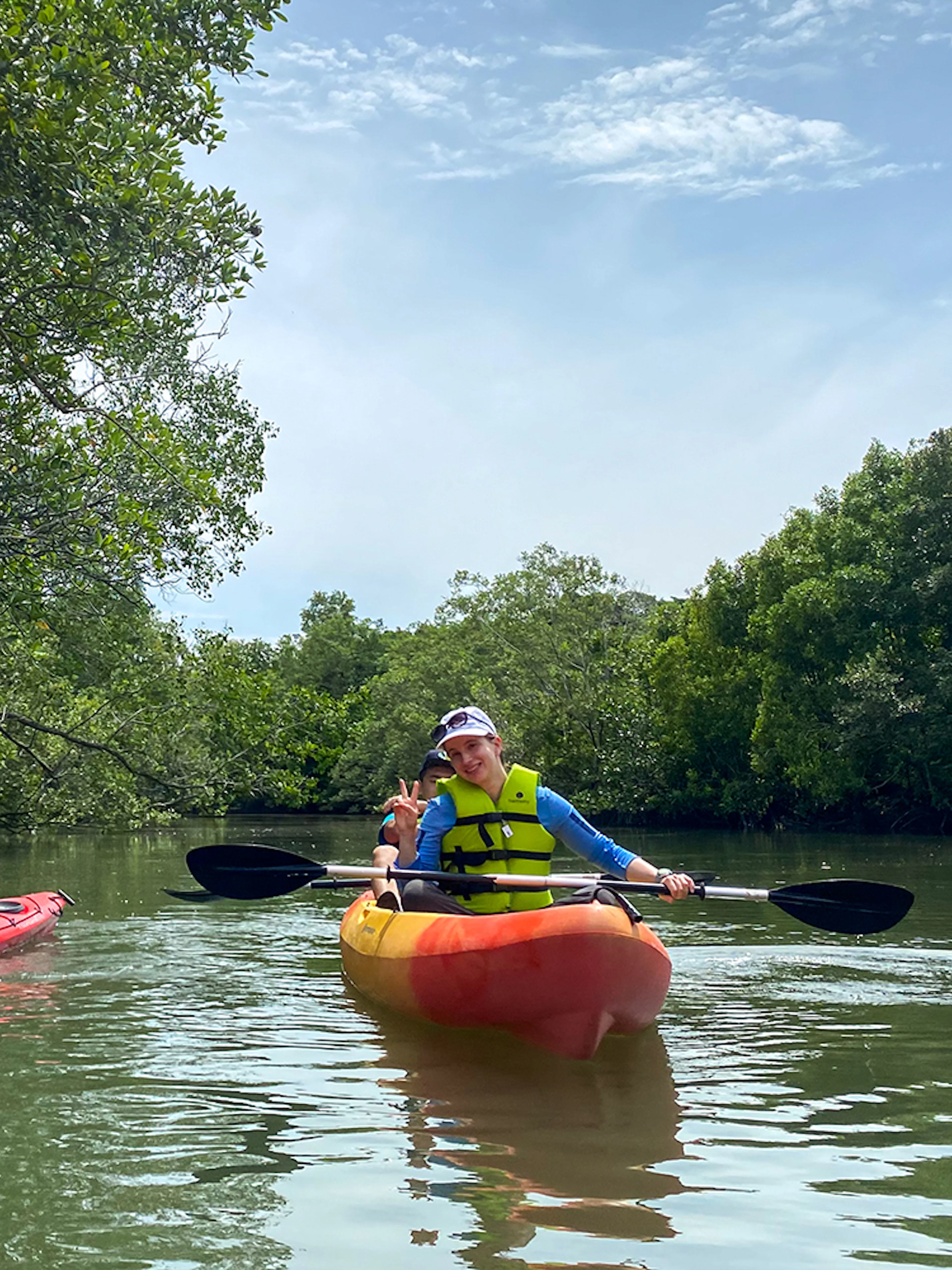 Kayakers paddling through mangroves at Pulau Ubin, Singapore.