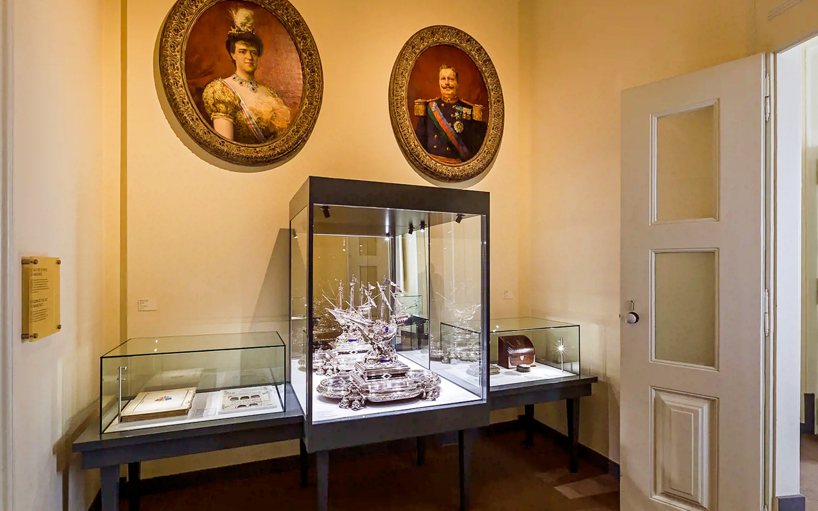 Display of historical artifacts and portraits inside Pena Palace, part of a guided tour from Lisbon.