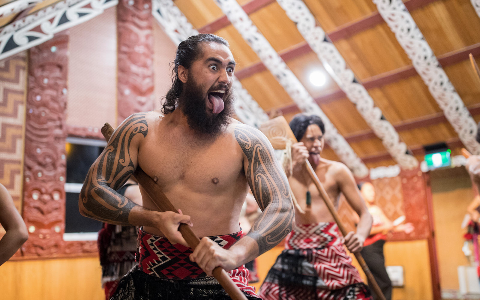 Maori performers in traditional attire during a cultural show in Rotorua, New Zealand.