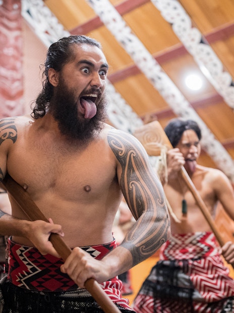 Maori performers in traditional attire during a cultural show in Rotorua, New Zealand.