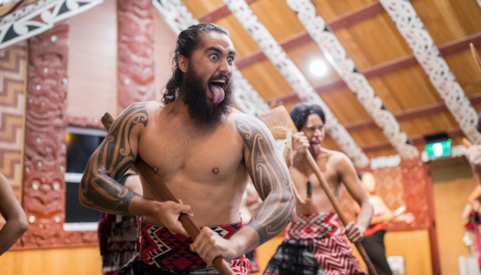 Maori performers in traditional attire during a cultural show in Rotorua, New Zealand.