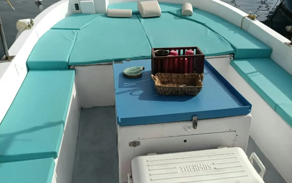 Boat deck with seating and a basket, part of Naples Sunset Boat Tour along Posillipo Coast.