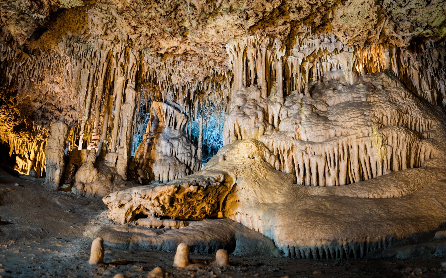 Stalactites and stalagmites in the illuminated interiors of Drach Caves, Mallorca.
