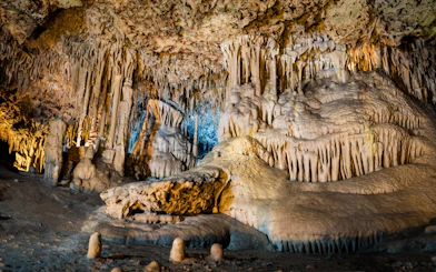 Stalactites and stalagmites in the illuminated interiors of Drach Caves, Mallorca.