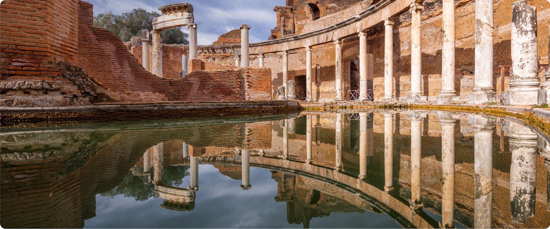 Ancient Roman ruins with columns reflected in water at Hadrian's Villa, Tivoli.