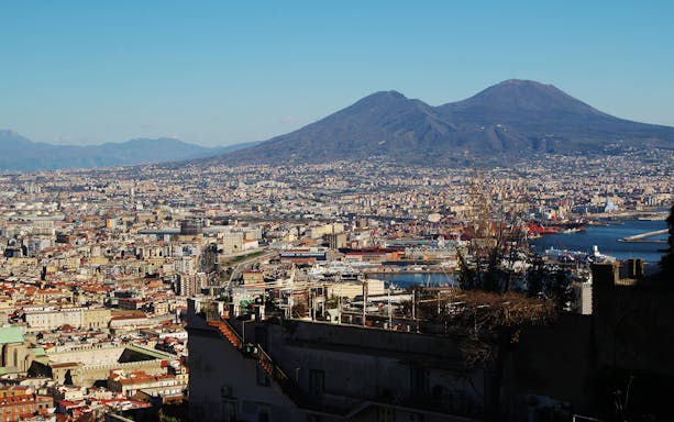 Naples cityscape with Mount Vesuvius viewed from Pedamentina steps.