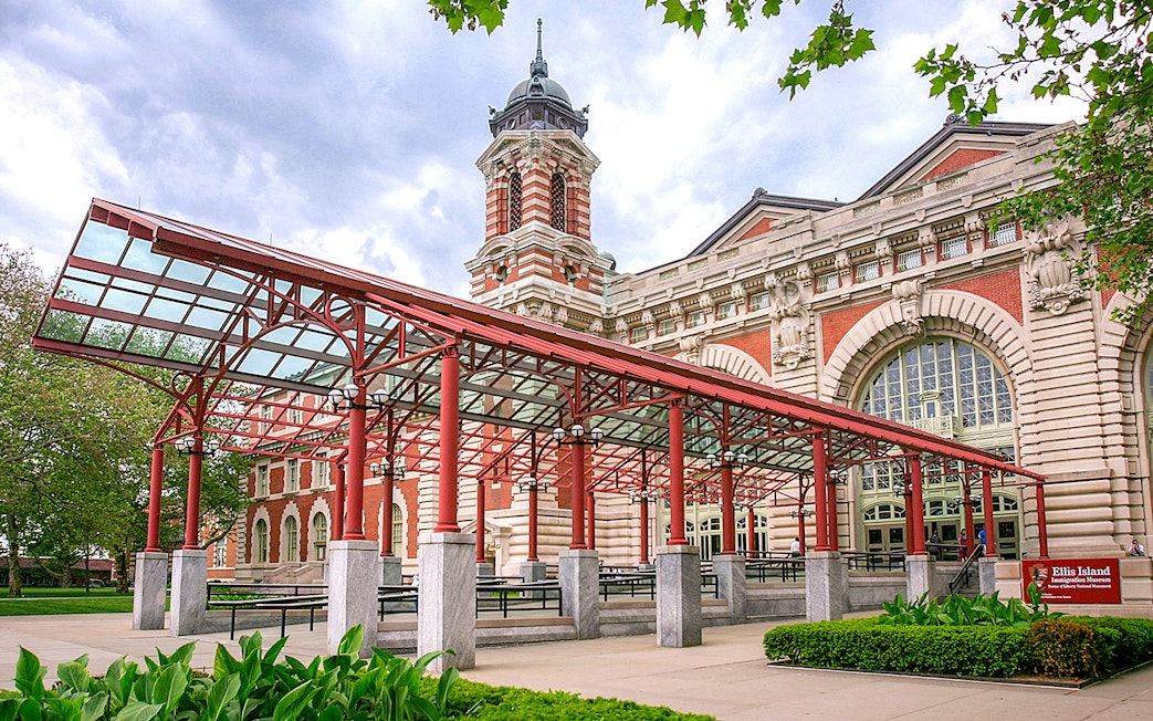 Ellis Island Immigration Museum entrance with red canopy and historic architecture.