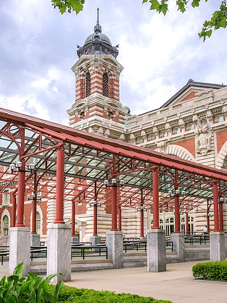 Ellis Island Immigration Museum entrance with red canopy and historic architecture.