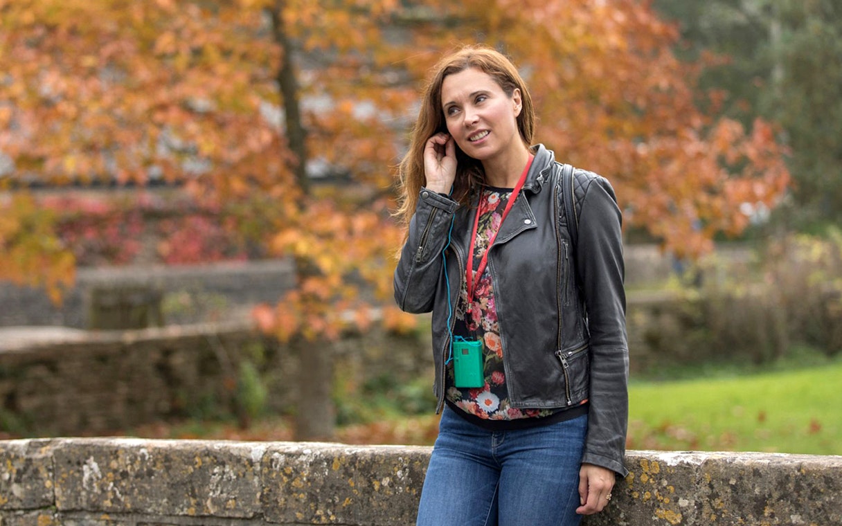 Tourist using personal audio headset during autumn tour.