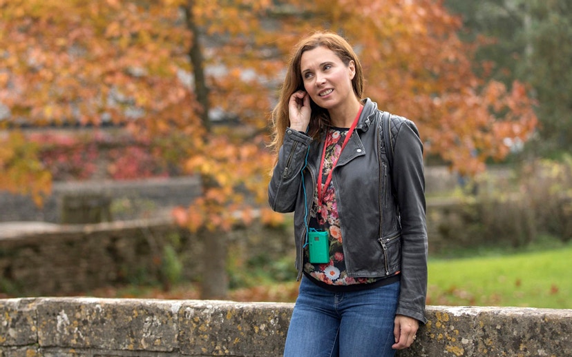 Tourist using personal audio headset during autumn tour.