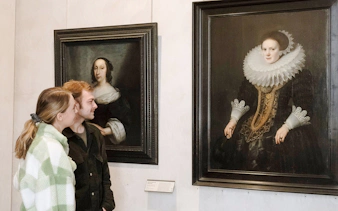 Visitors admiring portraits at the Museum of Fine Arts, Lyon, France.