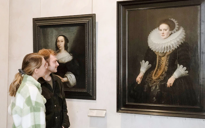 Visitors admiring portraits at the Museum of Fine Arts, Lyon, France.