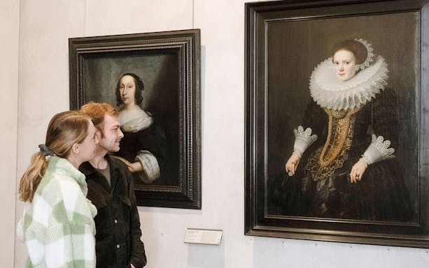 Visitors admiring portraits at the Museum of Fine Arts, Lyon, France.