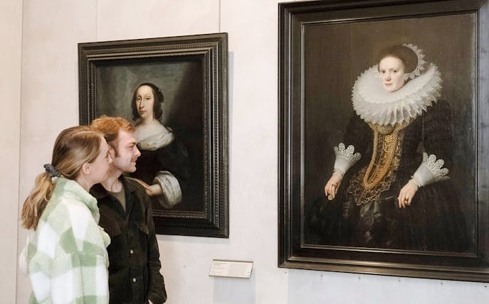 Visitors admiring portraits at the Museum of Fine Arts, Lyon, France.