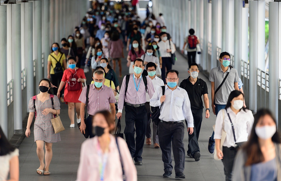 Crowd of people wearing surgical mask and walking