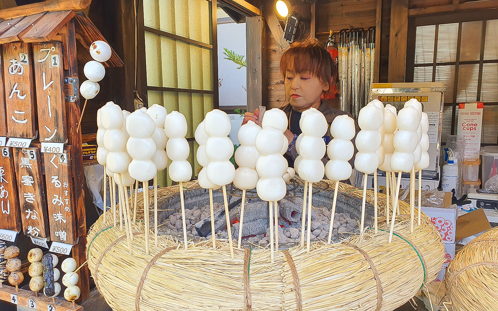 Grilled mochi skewers at a shop in Oshinohakai Village.