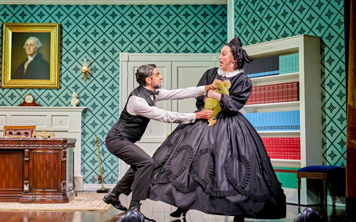 Man and woman in period costumes in a dramatic scene from "Oh Mary!" play.