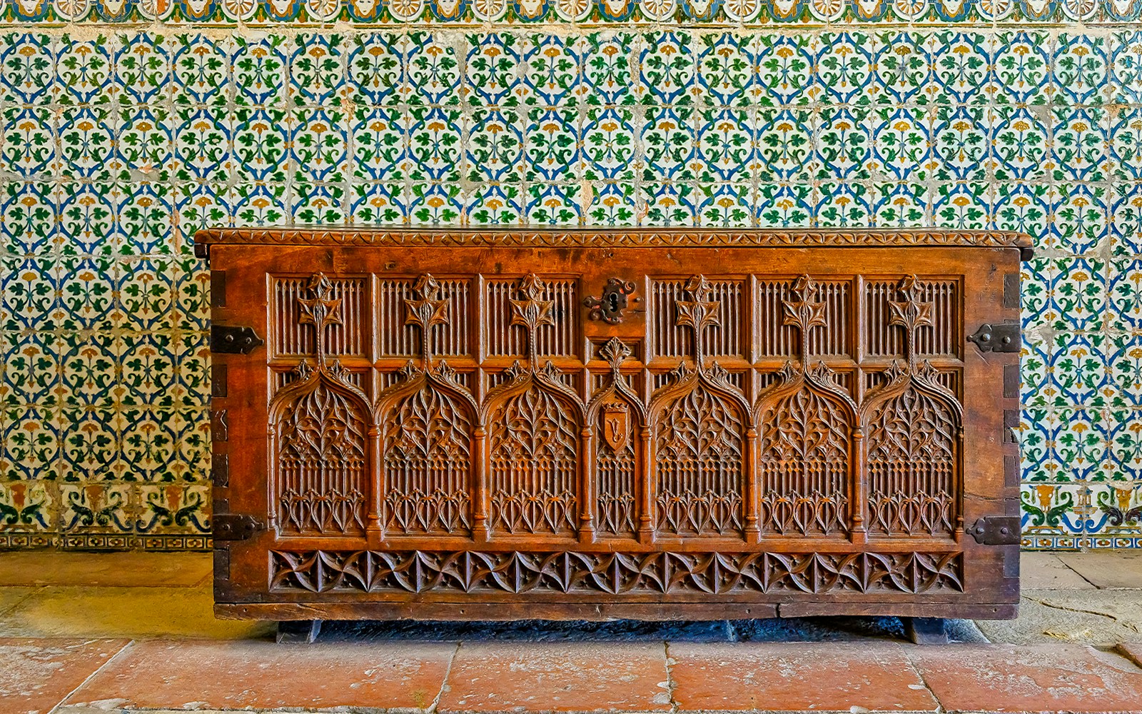 Carved wooden chest with intricate designs in Alcazar of Segovia, Spain.