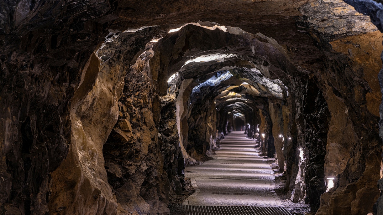 Aillwee Caves tunnel with illuminated rocky walls and pathway.