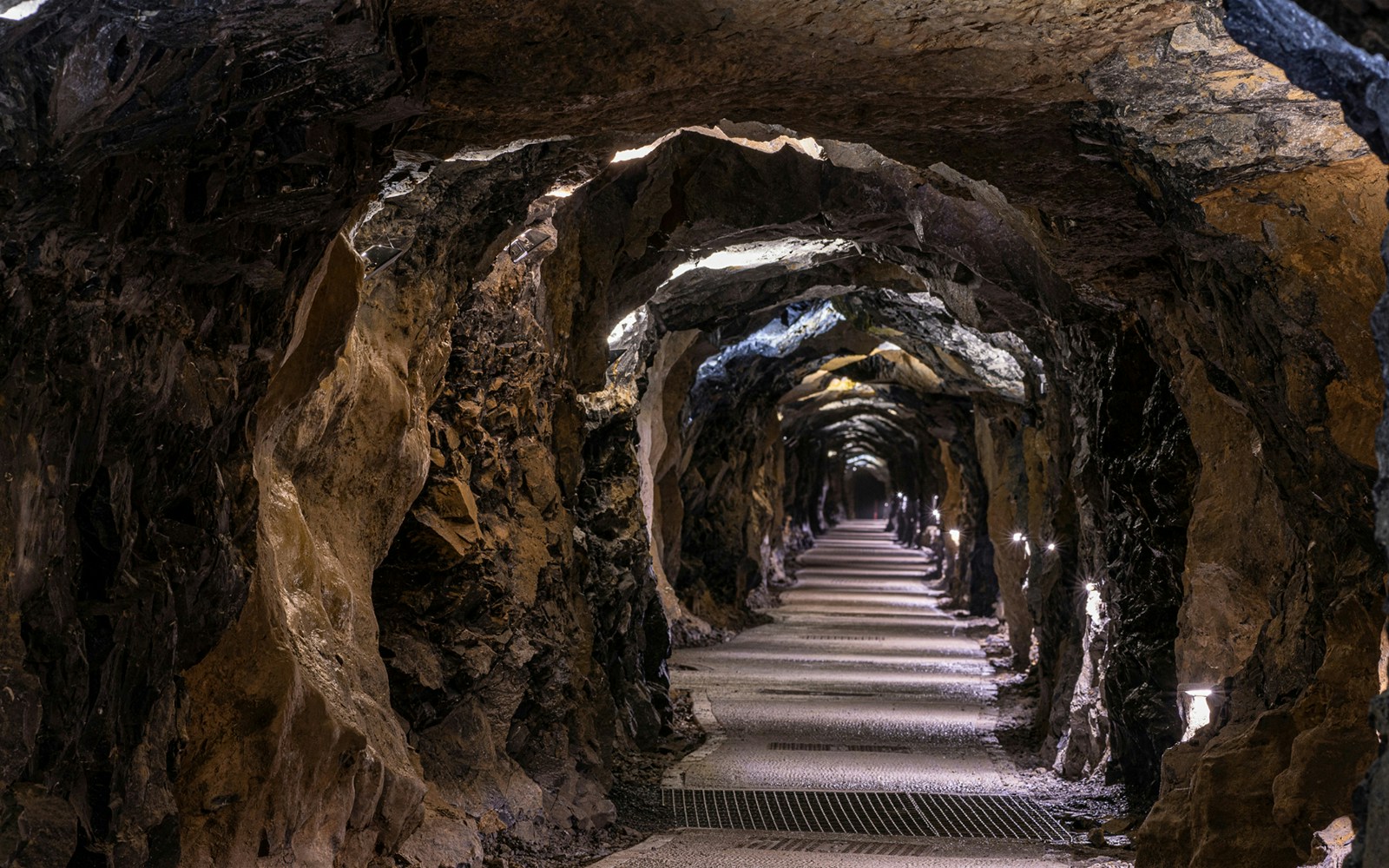 Aillwee Caves tunnel with illuminated rocky walls and pathway.
