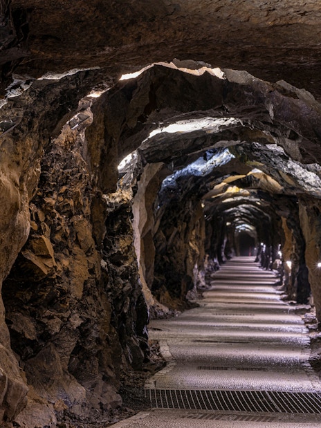 Aillwee Caves tunnel with illuminated rocky walls and pathway.