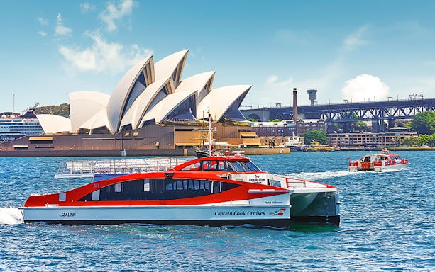 Captain Cook sightseeing boat on Sydney Harbour with Opera House in background.