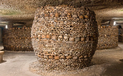 Barrel-shaped structure of bones and skulls in the Catacombs’ Ossuary, Paris.