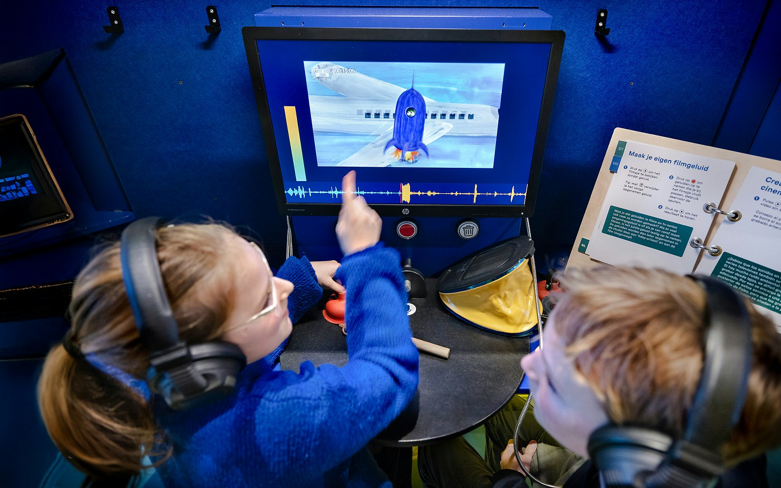 Kids interacting with a science experiment display at the museum.