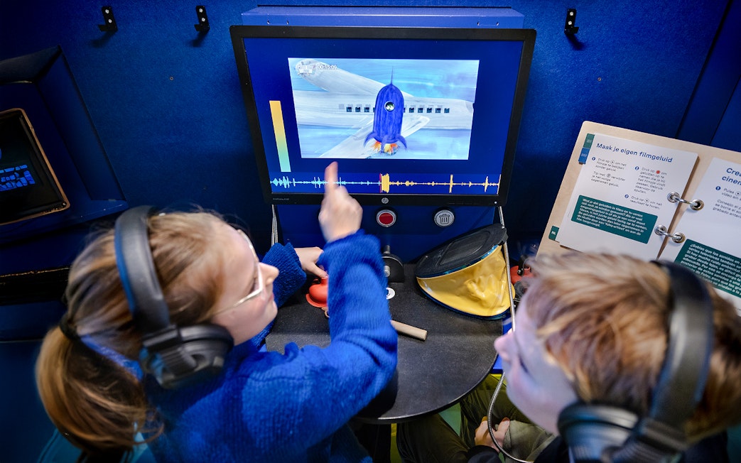 Kids interacting with a science experiment display at the museum.
