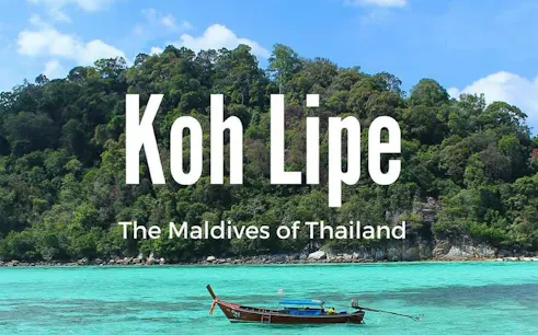 Ferry near lush island of Koh Lipe, Thailand, with turquoise waters.